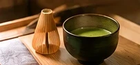 Matcha green tea and bamboo whisk for a Japanese tea ceremony